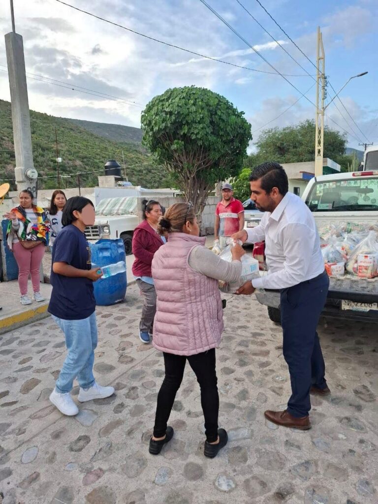 Trabajadores del municipio reparten despensas en La Estancia para apoyar a familias afectadas por lluvias.