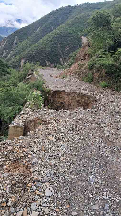 Socavón junto a estructura de concreto en camino serrano